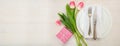 Valentines day table setting with pink tulips and a gift on white wooden background. Top view, copy space, banner Royalty Free Stock Photo