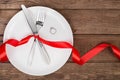 Valentines day table setting with plate, fork, knife, ring and ribbon. background Royalty Free Stock Photo