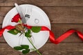 Valentines day table setting with plate, fork, knife, ring, ribbon and rose. background Royalty Free Stock Photo