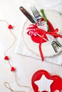 Valentines day table setting with plate, knife, fork, red ribbon Royalty Free Stock Photo