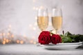 Valentines day table setting  red roses and champagne glasses on concrete background. Valentine `s greeting card - Image Royalty Free Stock Photo