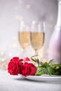 Valentines day table setting  red roses and champagne glasses on concrete background. Valentine `s greeting card - Image Royalty Free Stock Photo