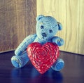 Valentines Day. Teddy Bear Loving cute with red hearts sitting alone. Vintage. Royalty Free Stock Photo