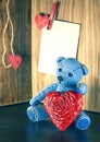 Valentines Day. Teddy Bear Loving cute with red hearts sitting alone. Vintage. Royalty Free Stock Photo