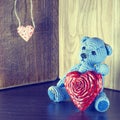 Valentines Day. Teddy Bear Loving cute with red hearts sitting alone. Vintage Royalty Free Stock Photo