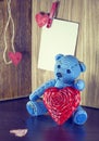 Valentines Day. Teddy Bear Loving cute with red hearts sitting alone. Vintage. Royalty Free Stock Photo