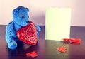 Valentines Day. Teddy Bear Loving cute with red hearts sitting alone. Vintage Royalty Free Stock Photo