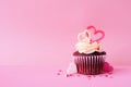 Valentines Day red velvet cupcake with a pink background Royalty Free Stock Photo