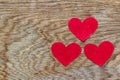 Valentines day three red hearts on wood with copy space