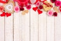 Valentines Day top border of hearts, flowers, gifts and decor on white wood