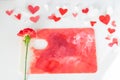 Valentines Day or wedding, invitation, scattered painted small cut out red, pink and white hearts with a red carnation