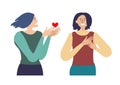 Valentines day. A woman gives another woman a heart with a confession of her feelings.