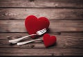 Valentines Day wooden board nner holding forks red heart two Royalty Free Stock Photo