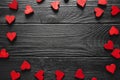 Valentines Day wooden hearts forming a border on a rustic wood background