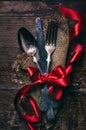 Valentines dinner background with vintage silverware and red ribbon on wooden table. Luxury restaurant menu for romantic Royalty Free Stock Photo