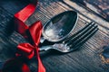 Valentines dinner background with vintage silverware and red ribbon on wooden table. Luxury restaurant menu for romantic Royalty Free Stock Photo