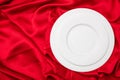 Valentines dinner, Empty set of white plates on red satin background