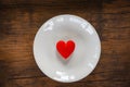 Valentines dinner romantic love food and love cooking Red heart on white plate romantic table setting decorated with red heart Royalty Free Stock Photo