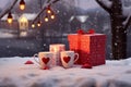 Valentines gift box with bow in snow with mugs
