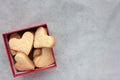 Valentines heart shaped cookies in a kraft gift box on a gray concrete background. Flat lay food. Royalty Free Stock Photo