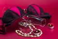 Valentines setup with erotic lingerie placed in between champagne glasses, pearl necklace and candles with a flame and fire. Royalty Free Stock Photo