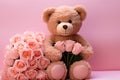 Valentines teddy bear clutches pink roses against a romantic pink backdrop