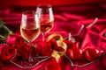 Valentines or wedding concept. Wine cups red roses and romantic