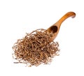 Valerian root on the wooden spoon, isolated.