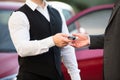 Valet Giving Car Key To Businessperson