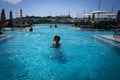 Woman in the infinity swimming pool at Aqualuna Beach Club, Valletta, Malta.