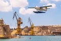 Valetta, Malta. Harbour Air seaplane De Havilland Canada DHC-3 Turbine Otter 9H-AFA is taking off in the Grand Harbour, Senglea.