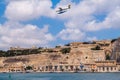 Valetta, Malta. Harbour Air seaplane De Havilland Canada DHC-3 Turbine Otter 9H-AFA is water landing in the Grand Harbour.