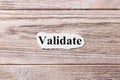 VALIDATE of the word on paper. concept. Words of VALIDATE on a wooden background