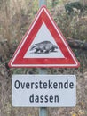 Badger crossing warning sign on the side of a rural country road Royalty Free Stock Photo