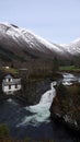 Valldola foss waterfall in river on Trollstigen route in snow in Norway Royalty Free Stock Photo