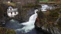 Valldola foss waterfall in river on Trollstigen route in snow in Norway Royalty Free Stock Photo