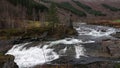 Valldola foss waterfall in river on Trollstigen route in snow in Norway Royalty Free Stock Photo