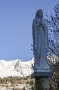 Panoramic view of the winter alps mountain of Valle d`Aosta and statue Virgin Mary