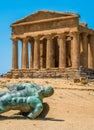 Temple of Concordia and the statue of Fallen Icarus, in the Valley of the Temples. Agrigento, Sicily, southern Italy.