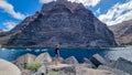 Valle Gran Rey - Man on scenic coastal hiking trail from Vueltas to Playas de las Arenas along massive cliffs in Valle Gran Rey