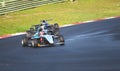 Racing car single seater modern formula in action at turn on wet asphalt Royalty Free Stock Photo