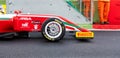 Racing car standing still on track close up on tire Pirelli name logo brand