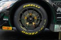 Pirelli racing tire on touring car wheel close up on track yellow name logo