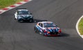 Electric cars battle in action racing on asphalt track, Cupra and Hyundai Royalty Free Stock Photo