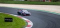 Electric touring car racing Hyundai in action on circuit asphalt track