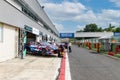 Hyundai Team electric racing car tuning work in circuit pit lane