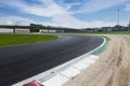 Motor sport circuit asphalt empty track turn exit with curb and gravel trap