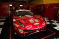 Racing Ferrari supercar in paddock