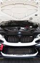 BMW M2 race car front view detail, open hood engine and Bmw logo