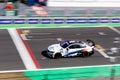 Fast Bmw touring race car on racetrack finish checkered line motion
